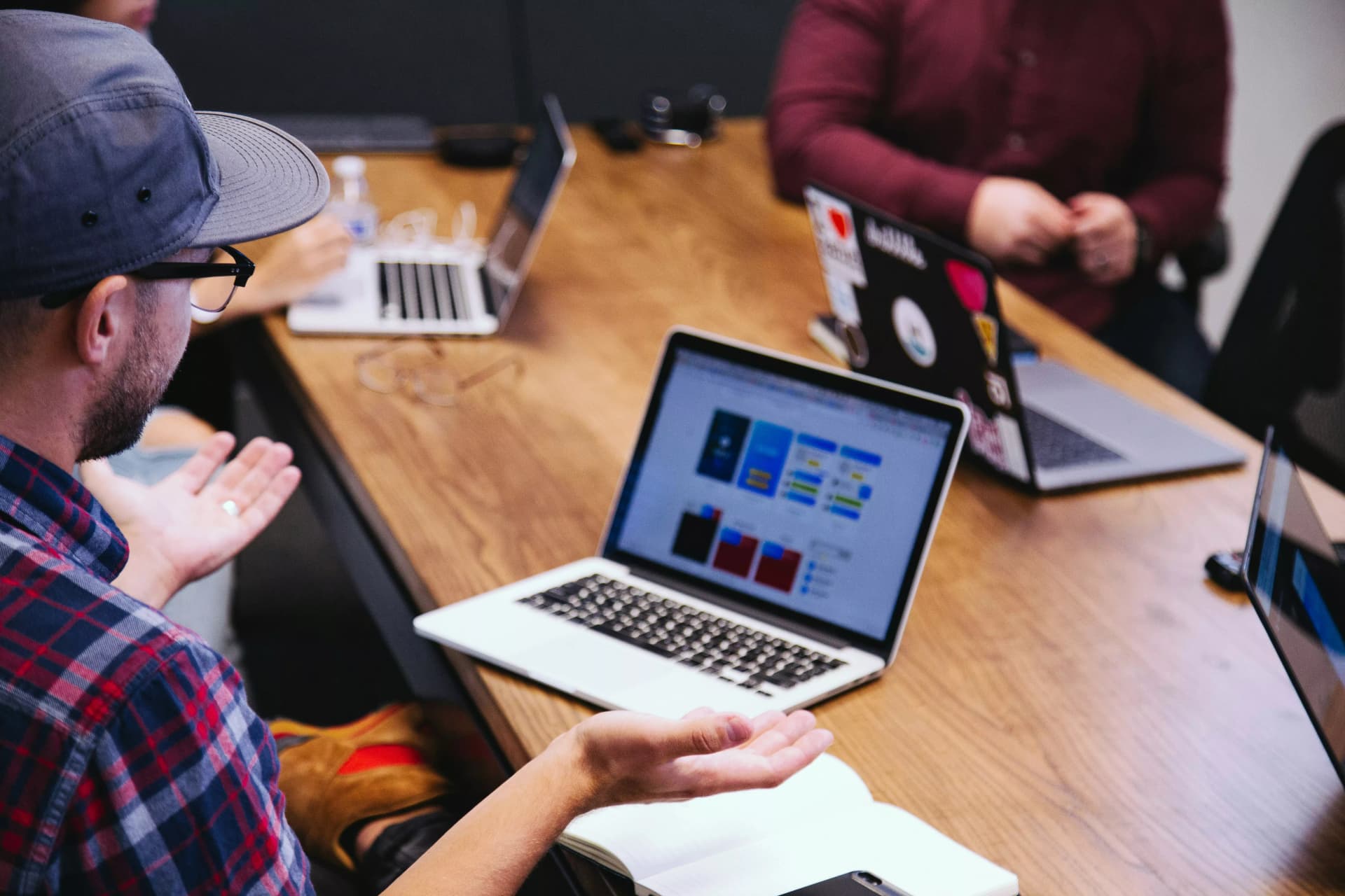 People discussing and working on their computer